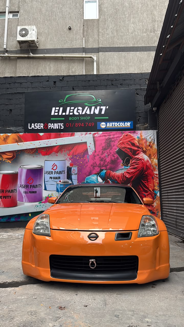 Orange Nissan 350Z outside Elegant Body Shop
